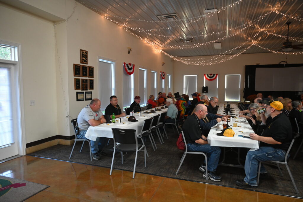 Attendees conversing at tables during event