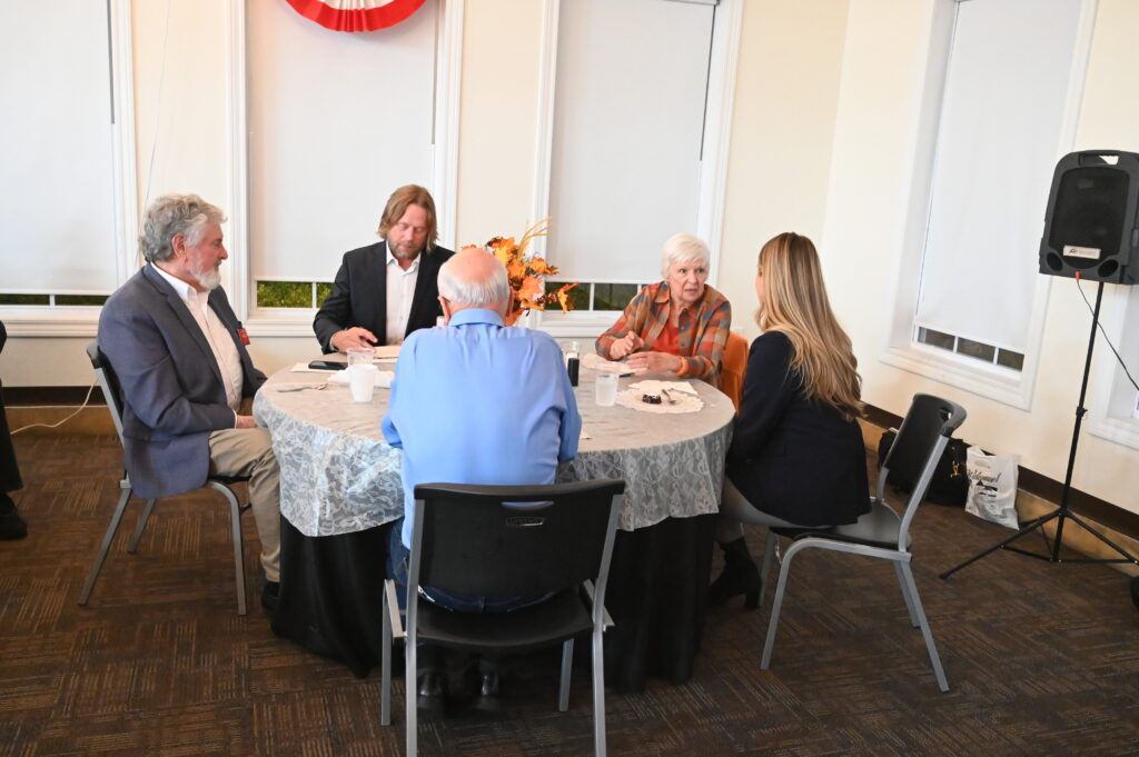 Attendees sitting at table talking