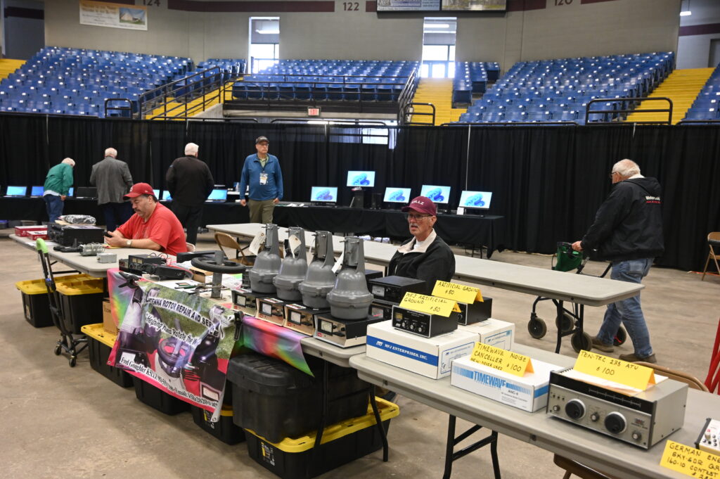 Exhibitors at vendor table during conference